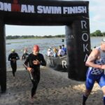 Triathlete exiting the swim in an Ironman Triathlon