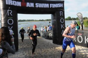 Triathlete exiting the swim in an Ironman Triathlon